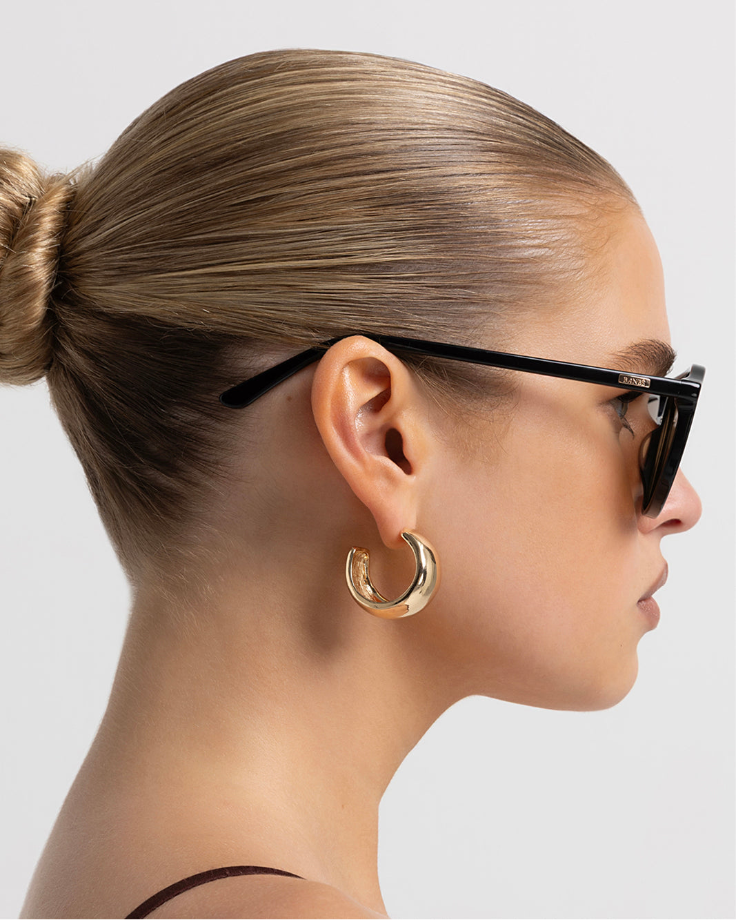 Oversized women's aviator sunglasses with a, flat-top brow bar, keyhole cut, double bridge, and slim arms.