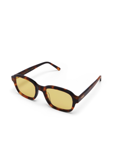 Sunglasses with tortoiseshell frame and yellow lenses on a white background