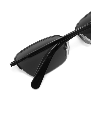 Women’s metal cat-eye sunglasses with UV protection, thin frame, dark tinted lenses, close view